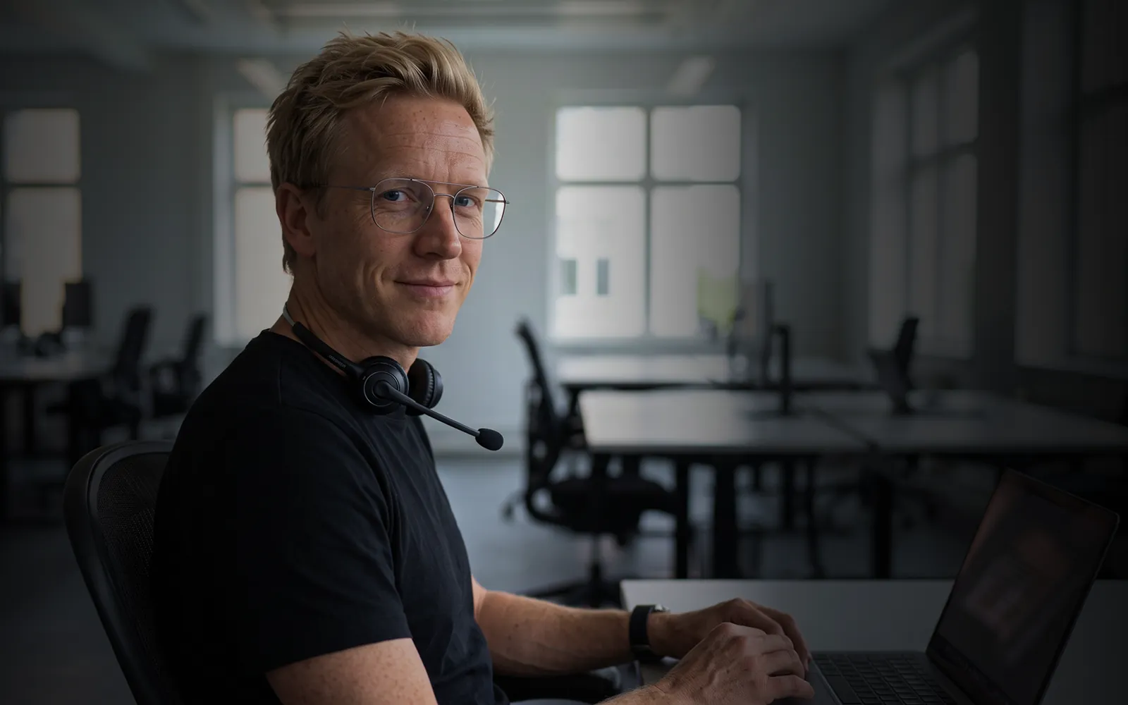 MR HARRY® wearing a headset at his desk